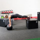 Woman Training Elevated Foot Push-Ups on Body-Solid Plyo Box in Gym