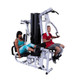 Body-Solid (EXM3000LPS) Commercial Multi-Gym - Two Users Exercising