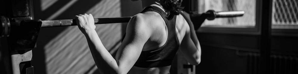 Woman Exercising on Workout Rack in Commercial Gym