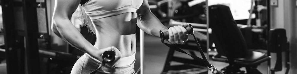 Woman Exercising with Cable Attachments in Commercial Gym