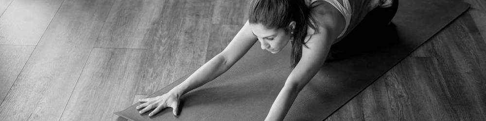 Woman Working Out on Exercise Mat in Commercial Gym