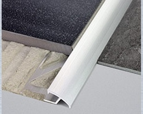 Aluminium sloping profile used as a ramp between two surfaces of different heights to prevent a trip hazard and protect the edges of adjacent floor coverings