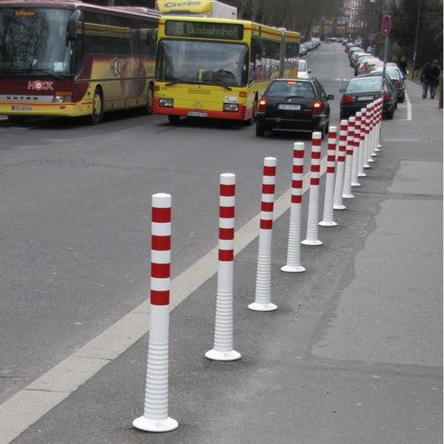 Red/white flexible bollard along bus route.
