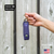 1/2oz Police Magnum twist lock pepper spray holster held in hand showing compact size and keychain attachment
