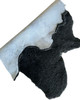 Black short wool natural sheepskin rug, folded to show the natural leather back.