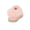 Close up of a pink sheepskin slipper showing its closed heel and fluffy collar.