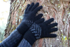 Black wool gloves with New Zealand's silver fern icon create a continuous icon.