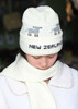 White beanie hat made of pure merino wool, with sheep motif and the words New Zealand at the border.