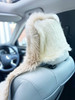 Rear view of car seat showing the secure stretch synthetic backing on headrest in sand colour
