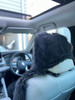Rear view of car seat showing the secure stretch synthetic backing on headrest in black