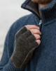 A man wearing open finger gloves made of knitted possum fur, layered with polyprop for added durability.