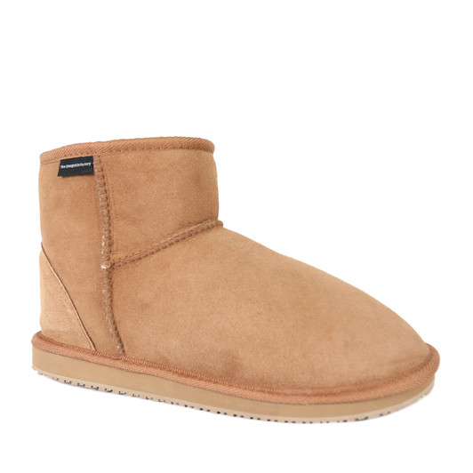 Ankle sheepskin boots in chestnut brown color, classic utilitarian design, more popularly known as Ugg boots. Ankle sheepskin boots in chestnut brown color, classic utilitarian design, more popularly known as Ugg boots.