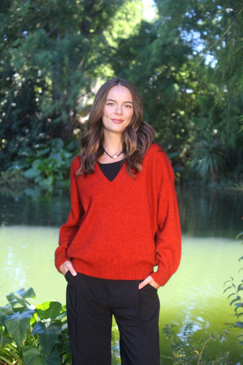 Boxy style V-neck jumper for women, made of possum merino wool, pumpkin orange color.
