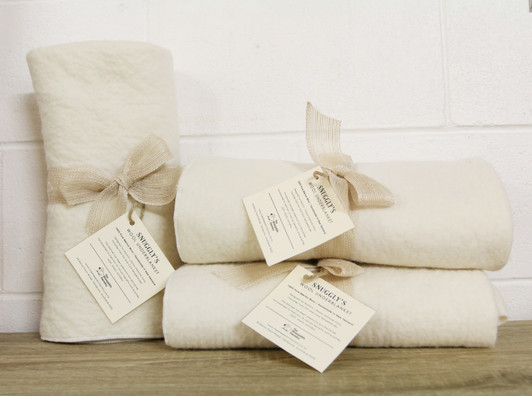 Snuggly wool underblanket tied in a big bow looking gift ready.