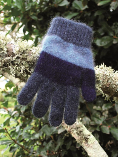 A thick child's glove with wide stripes of gray, light blue and denim blue displayed on a tree branch in a garden. A thick child's glove with wide stripes of gray, light blue and denim blue displayed on a tree branch in a garden.