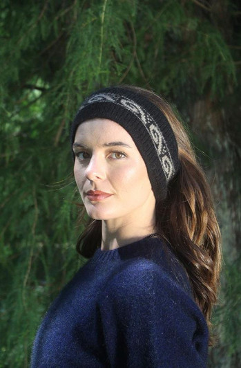 Women's black headband with koru motif.