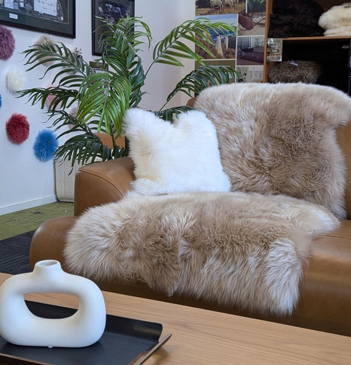 Living room with a long wool sheepskin rug draped on a couch.