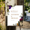 Modern and stylish garden wedding welcome sign clipped to an easel. 