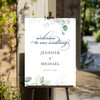 An ethereal garden wedding welcome sign clipped to an easel. 