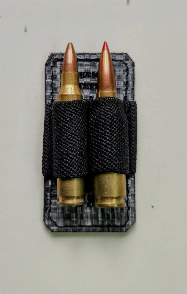 Can securely hold 2 smaller rifle rounds. Pictured here is a .223 wylde (left) and a 6.5 Grendel (right).