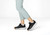 Orthofeet Approach Shot Hands-Free Stretch Women's Golf Sneakers - Black - Lifestyle View - 2 White/silver
