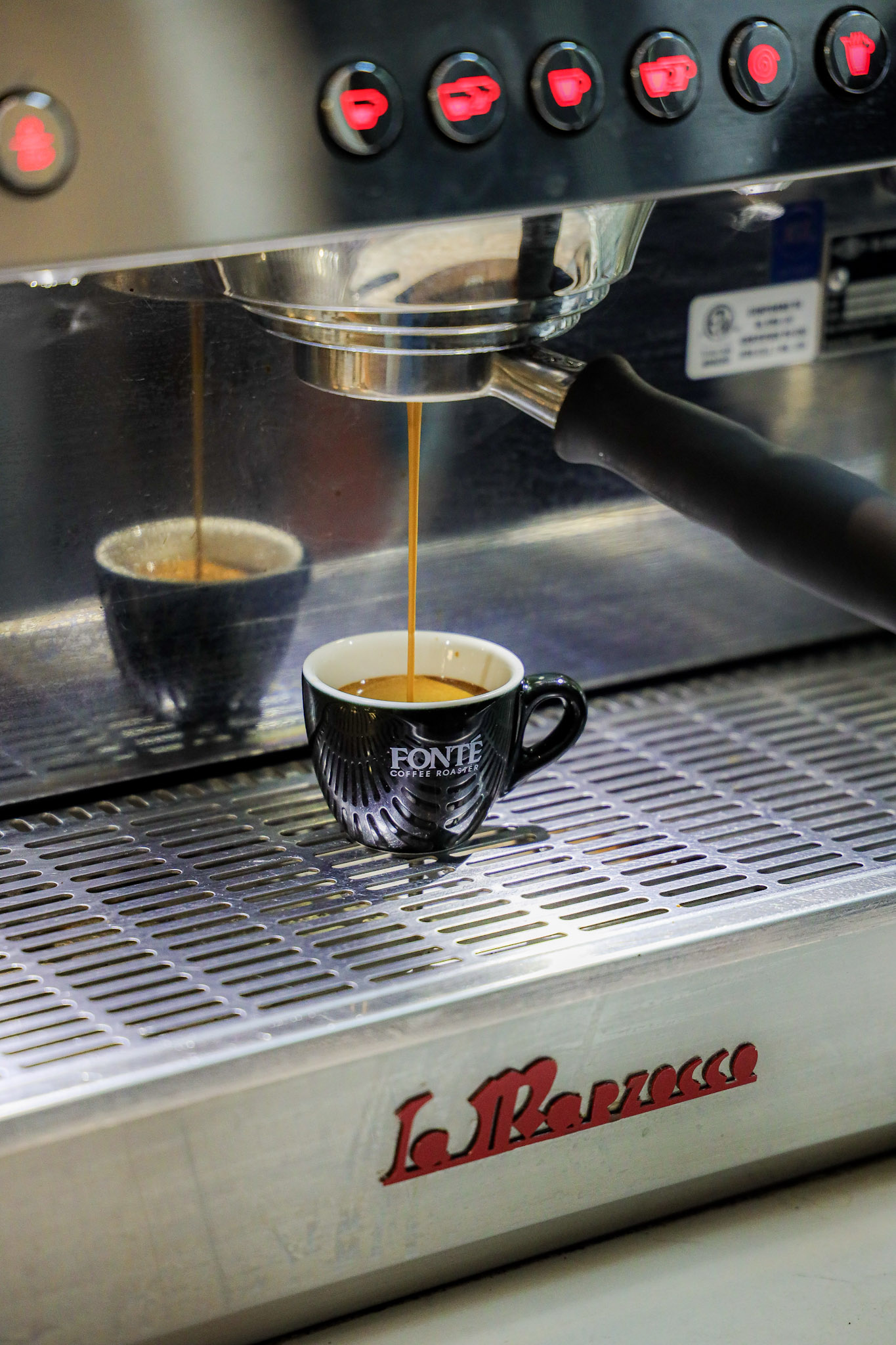 pulling a shot of F2 espresso on a La Marzocco machine