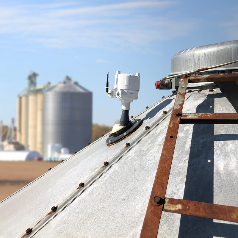 Laser level sensor mounted atop a feed bin to measure animal feed inventory