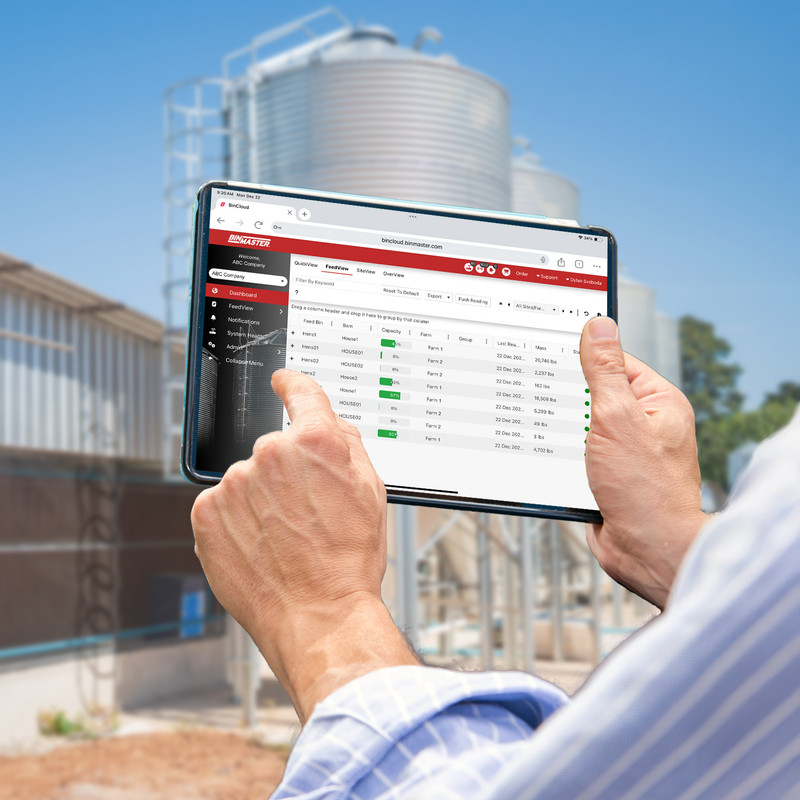 BinMaster enables digital feed monitoring for this worker who is viewing feed inventory in real-time on a tablet
