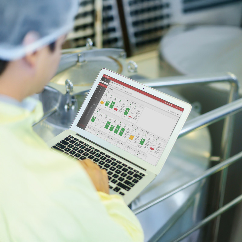 Food & beverage processing worker monitors current levels in process and storage tanks to ensure seamless operation