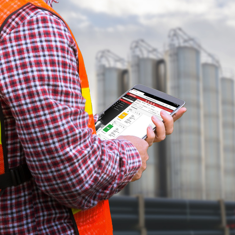 Plastic operations manager views resin tank levels from a tablet. ResinView enables anywhere, anytime visibility into plastic storage silos