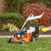 Professional landscaper using Stihl RM 756 YC mower on large lawn