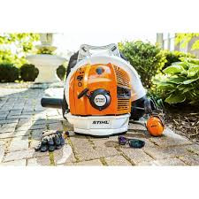 Stihl BR 700 X blower in action on commercial landscaping cleanup