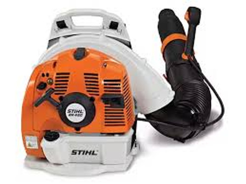 Professional landscaper using Stihl BR 450 blower for debris cleanup Professional landscaper using Stihl BR 450 blower for debris cleanup