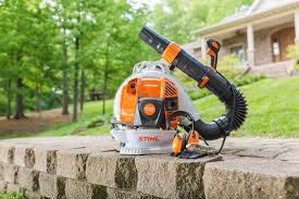 Professional landscaper using Stihl BR 600 blower for heavy-duty cleanup