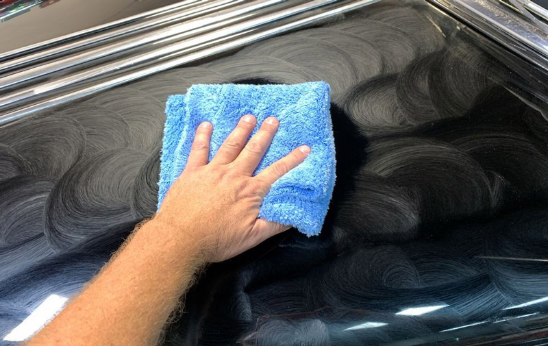 Speed Master Towel buffing off dried on wax from car.