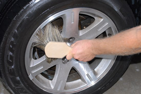 Use a Boar's Hair Wash Brush on the wheel face.