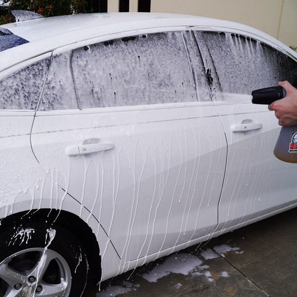 Spraying CarPro Reset Shampoo onto car using a foam gun