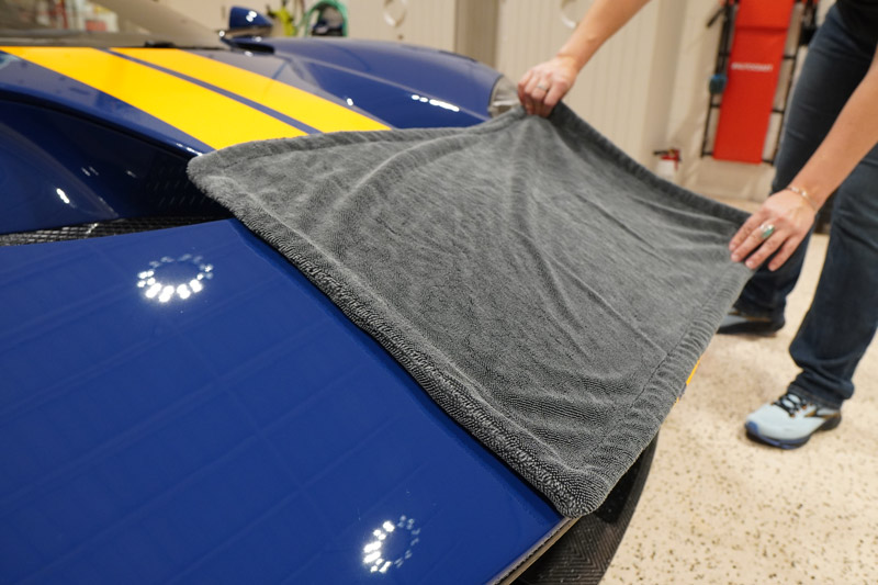 Drying the paint with a drying towel.