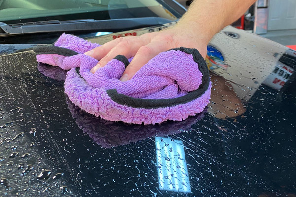 Washing one panel at a time with a rinseless washing solution