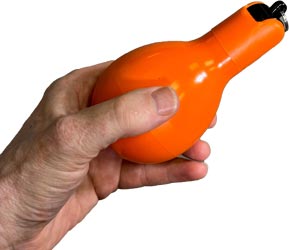 wizzball-hand-whistle-held-in-hand-orange.jpg