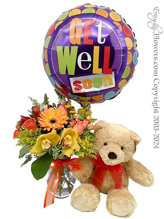 A bright yellow and orange floral bouquet with a bright and colorful helium filled get well soon balloon and a stuffed animal.