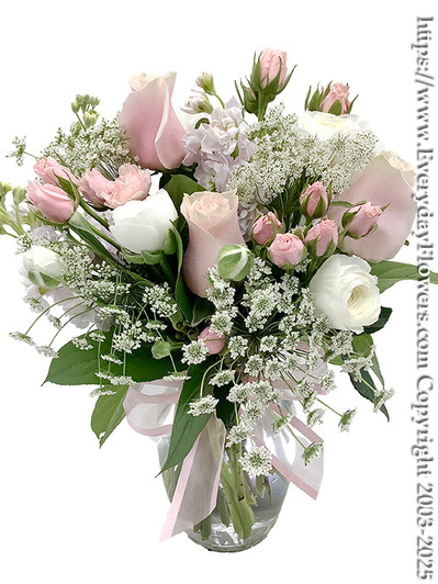 Pink Blooms - Pink roses with white lisianthus & queen annes lace arranged in a 8 inch glass vase with a pink bow tied around the vase.