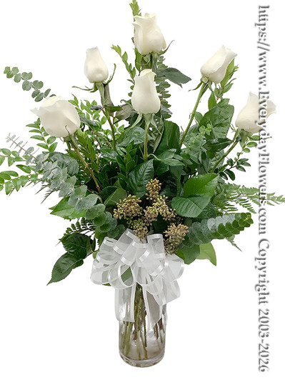 White Rose Bouquet featuring six long stem white roses arranged with fresh eucalyptus and seasonal greenery in a clear glass vase with a white ribbon by Everyday Flowers