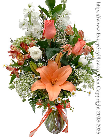 Ivory garden orange and white flower arrangement - Using orange asiatic lilies, orange roses, orange alstroemeria,  bells of ireland, arranged in a 8 inch tall glass vase with a orange bow tied around the vase.