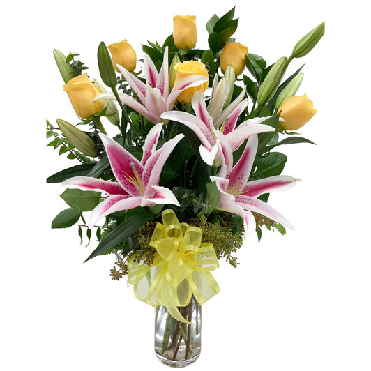 Half dozen yellow roses with stargazer lilies arranged in a cylinder vase with fresh greenery and a yellow bow.