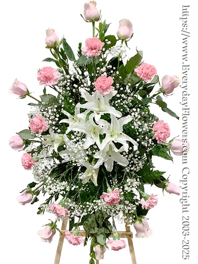 White lily and pink rose standing funeral spray on easel