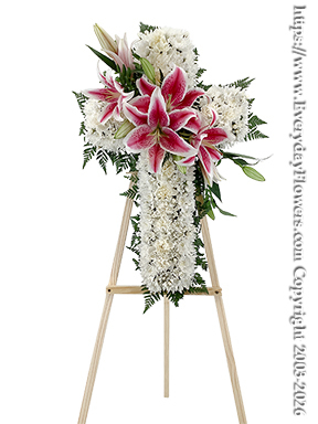 White Sympathy Cross With Stargazer Lilies - 24 Inch tall cross shaped form covered with white chrysanthums. A spray of stargazer lily blooms is placed in the middle of the cross.