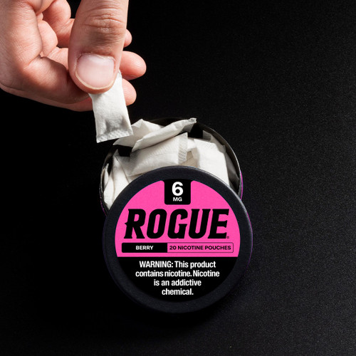 Grabbing a Rogue nicotine pouch from can