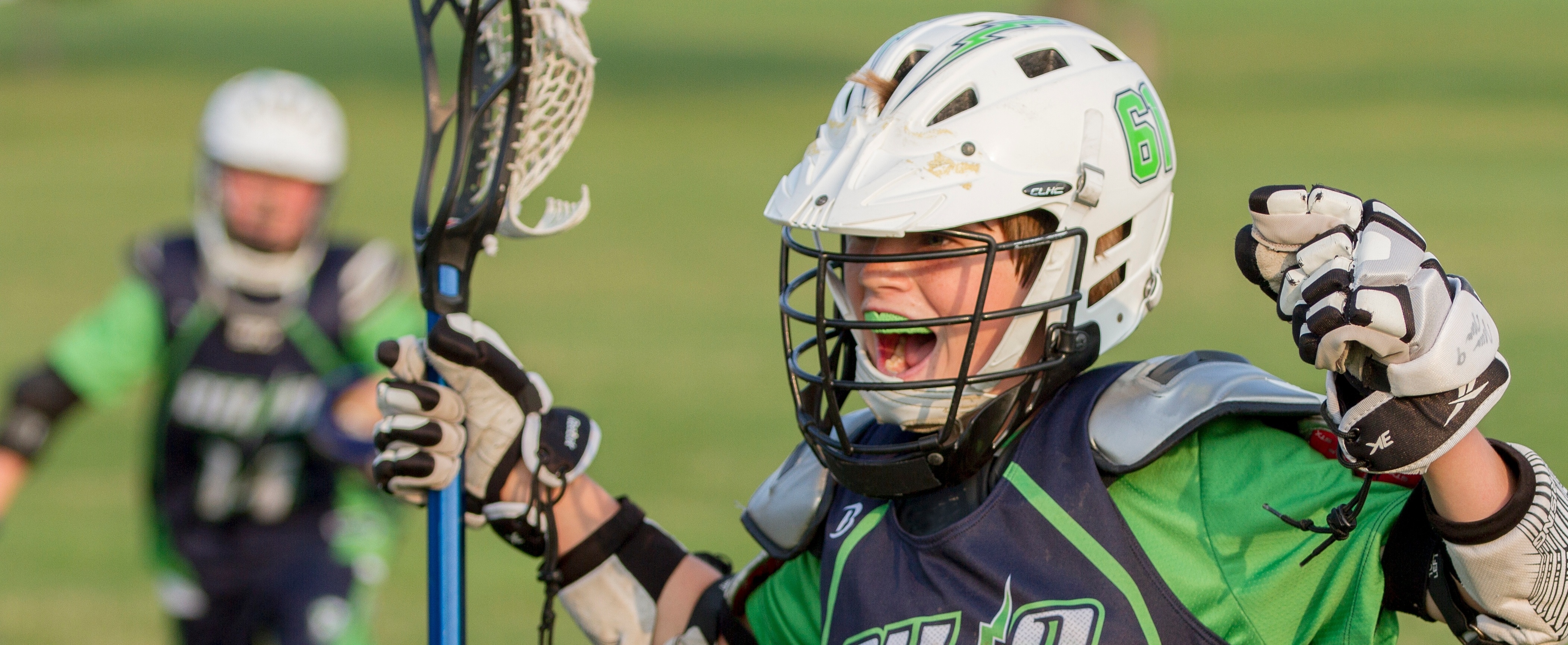 Child playing lacrosse showing excitement