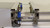 Side view looking down the J-series conveyor rails, with a sensor at each end and a PCB at the entrance.
